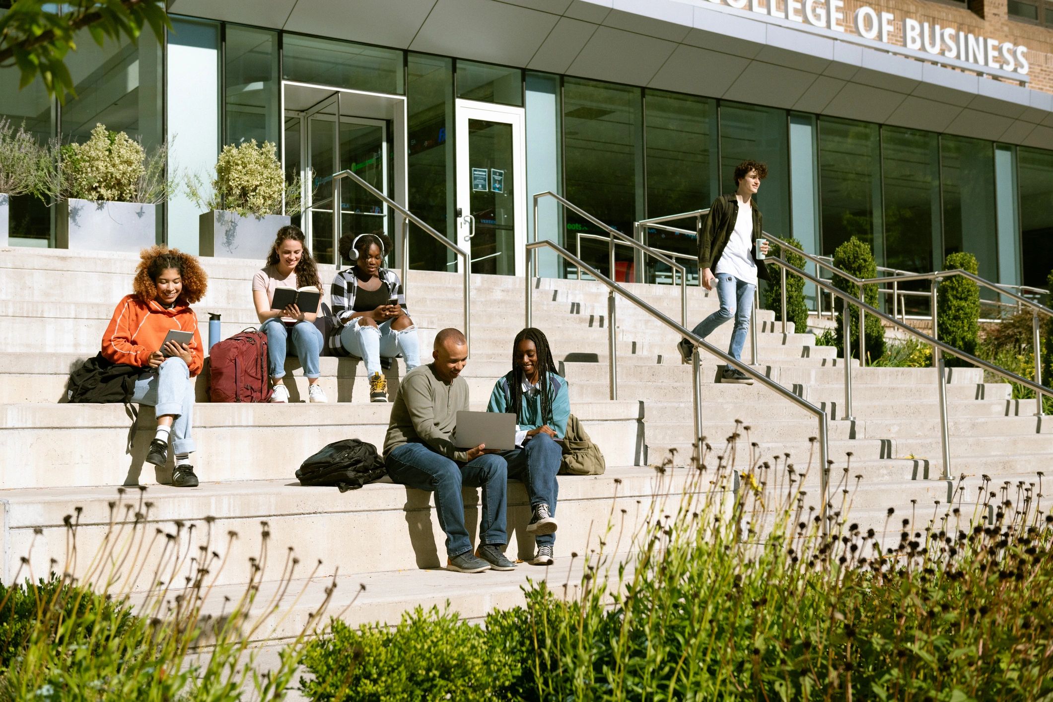 Group of students sitting outside university building